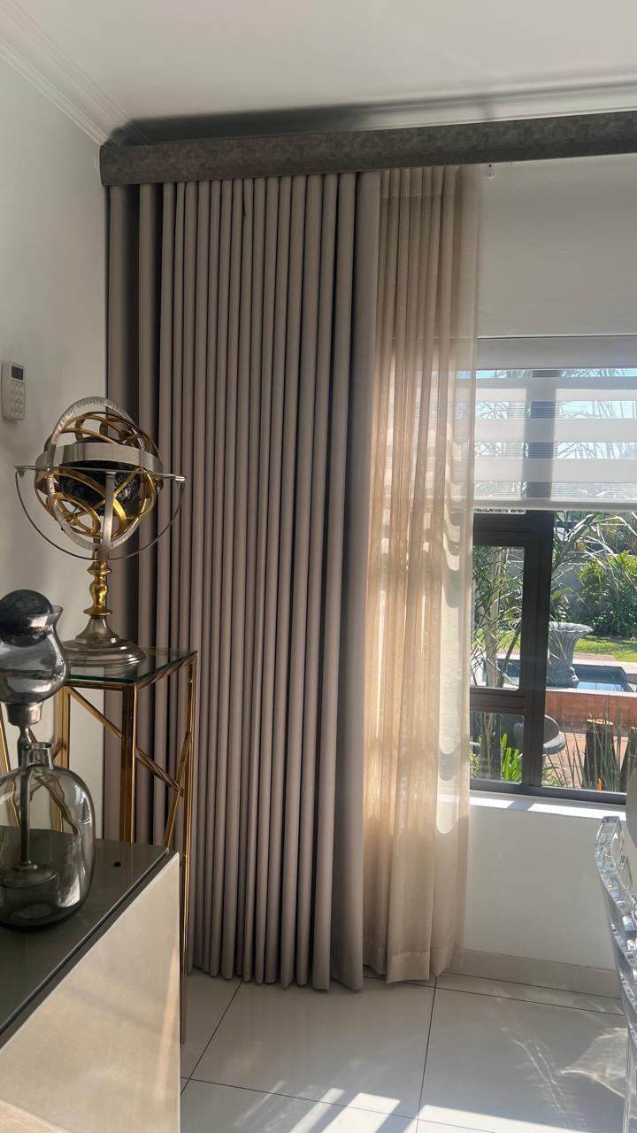 Wave-fold curtain and sheer paired beside a poolside window